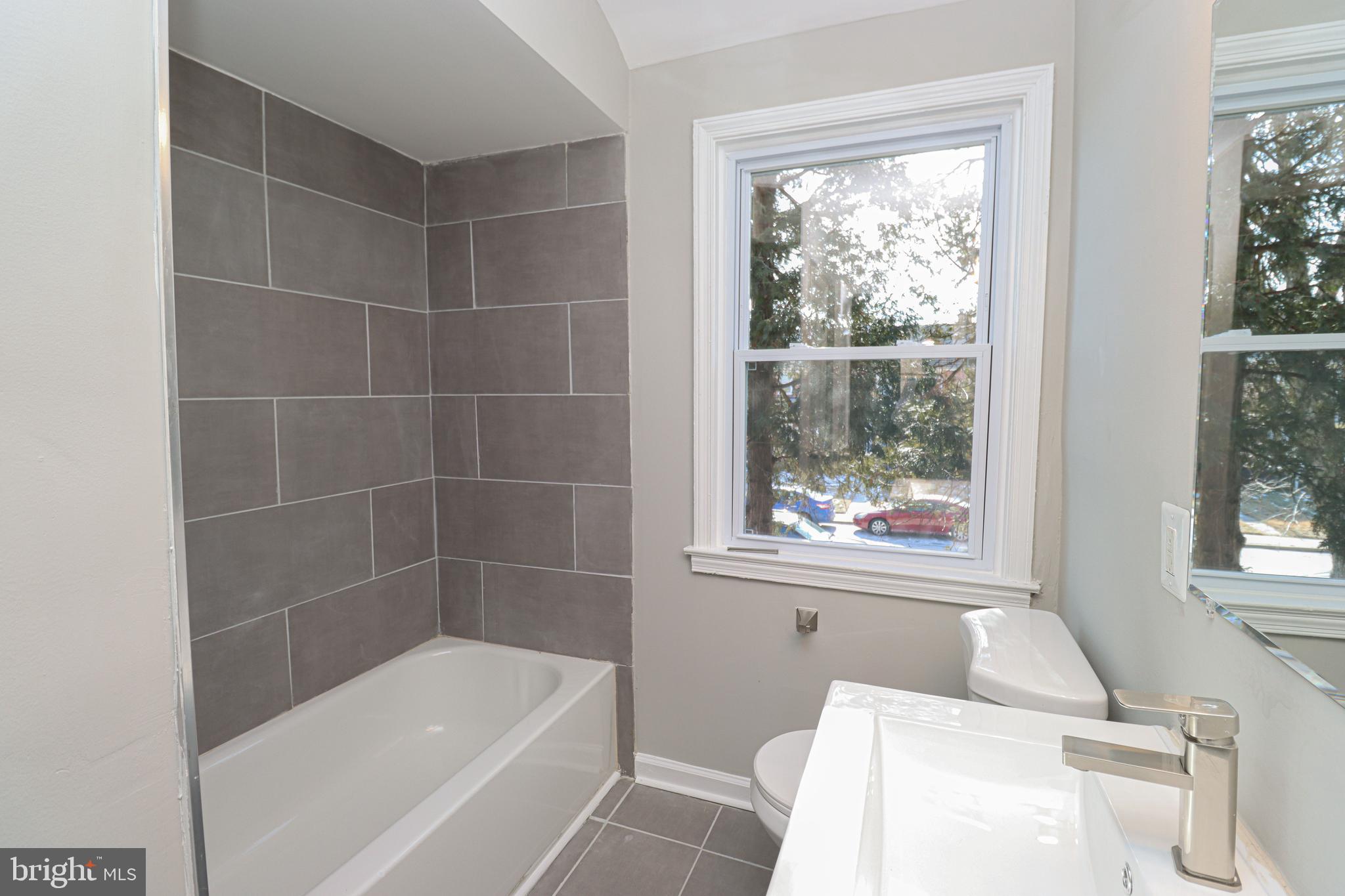 1260 Cedarcroft Road Baltimore, MD 21239 - Photo 15 of 30 a bath tub sitting next to a window
