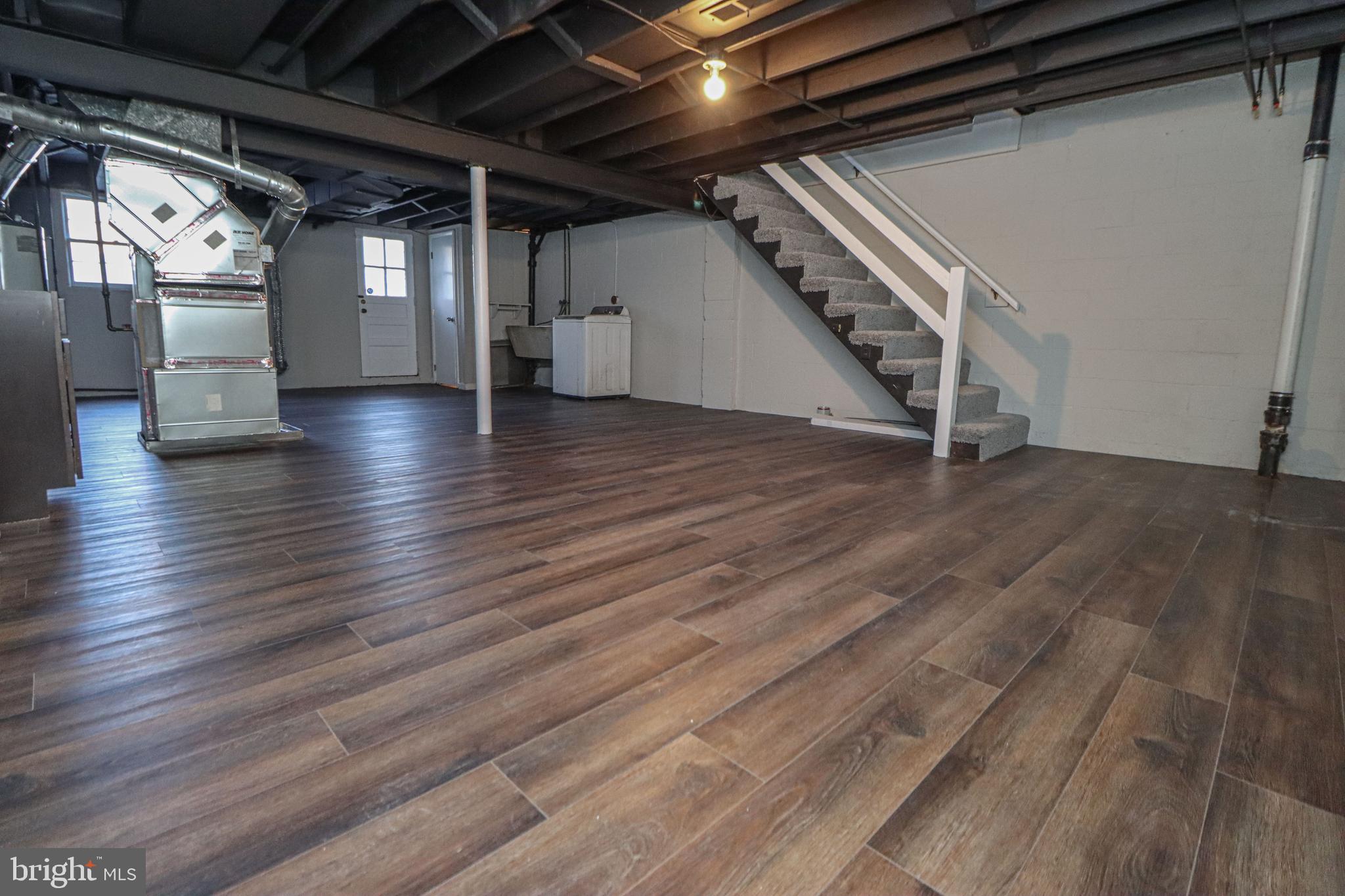 1260 Cedarcroft Road Baltimore, MD 21239 - Photo 26 of 30 a view of an empty room with wooden floor