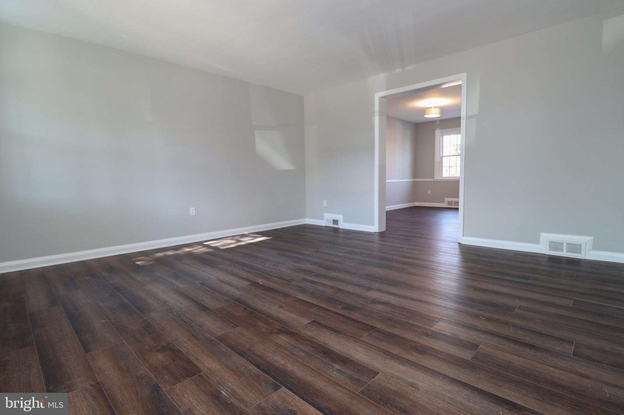 1260 Cedarcroft Road Baltimore, MD 21239 - Photo 4 of 30 a view of an empty room and wooden floor