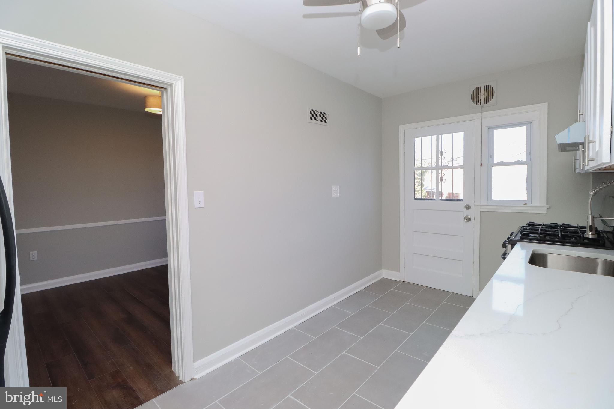 1260 Cedarcroft Road Baltimore, MD 21239 - Photo 10 of 30 a view of a kitchen with a sink dishwasher and a fireplace