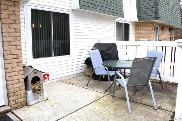 a view of a chair and tables in the patio