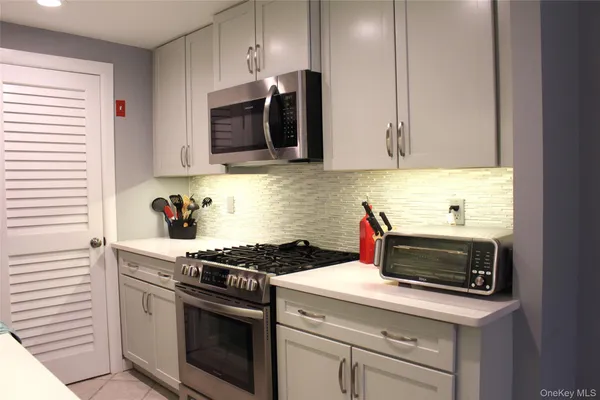 a kitchen with a stove and a microwave