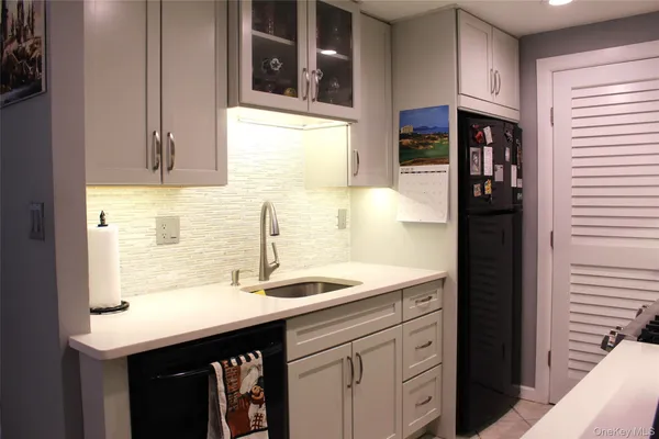 a kitchen with a sink and cabinets