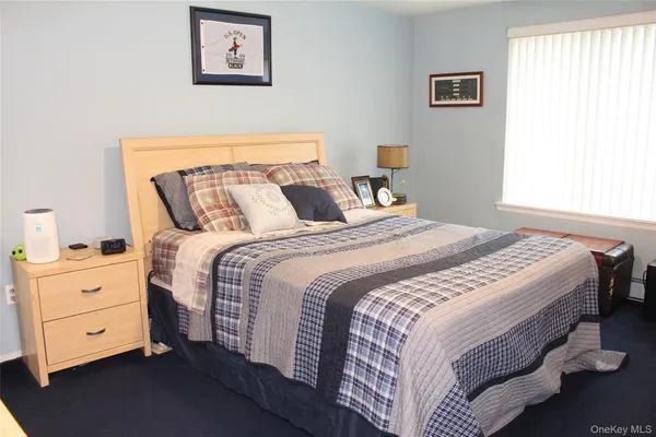 a bedroom with a bed and a night stand