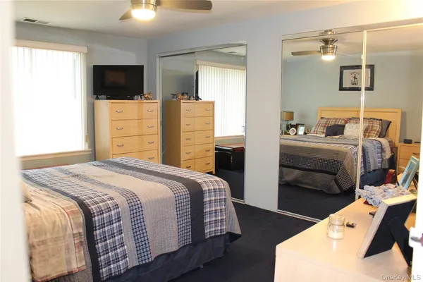 a bedroom with a bed and a television