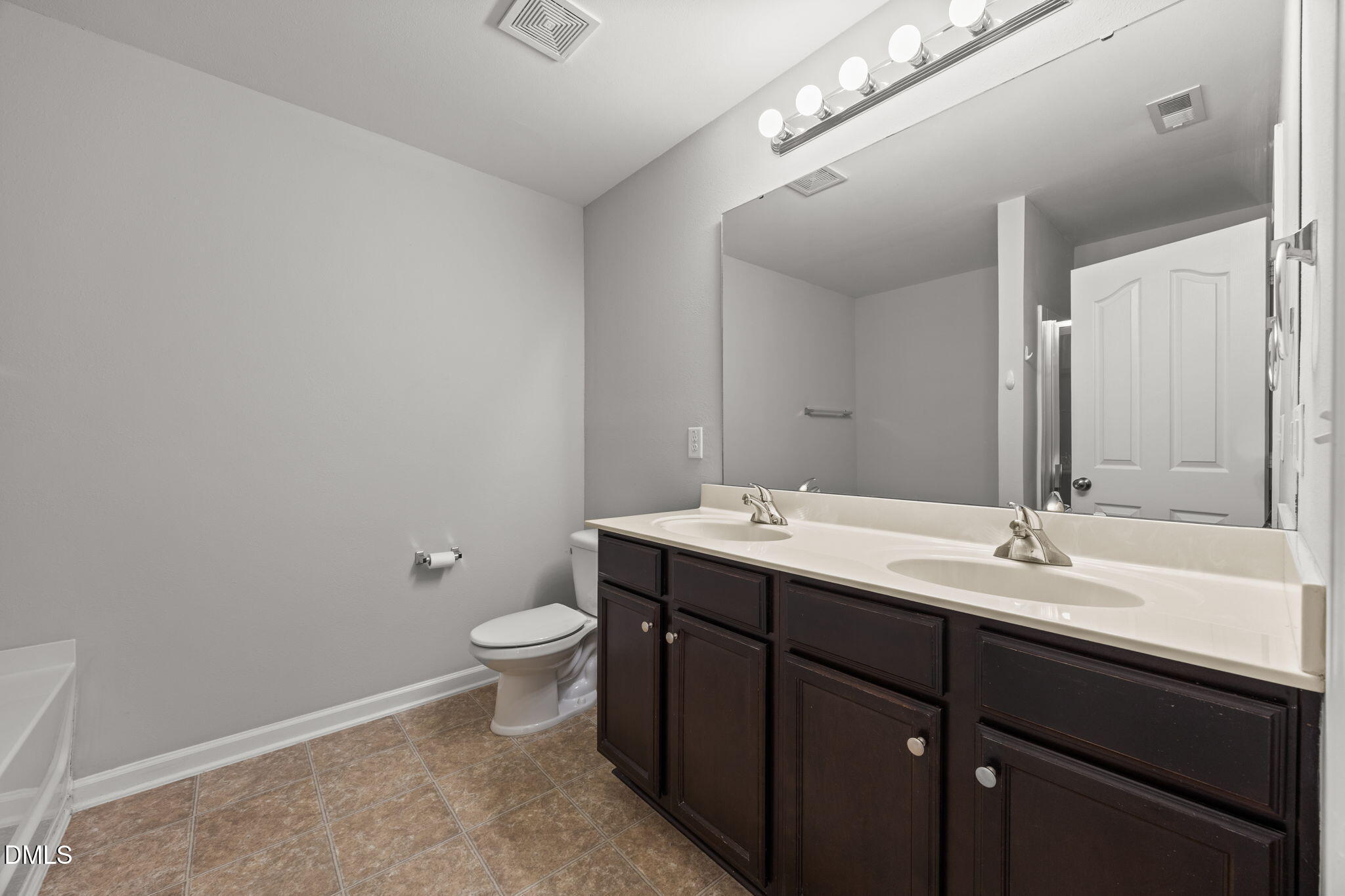 45 Crane Way Bunnlevel, NC 28323 - Photo 24 of 35 a bathroom with a double vanity sink toilet and a mirror