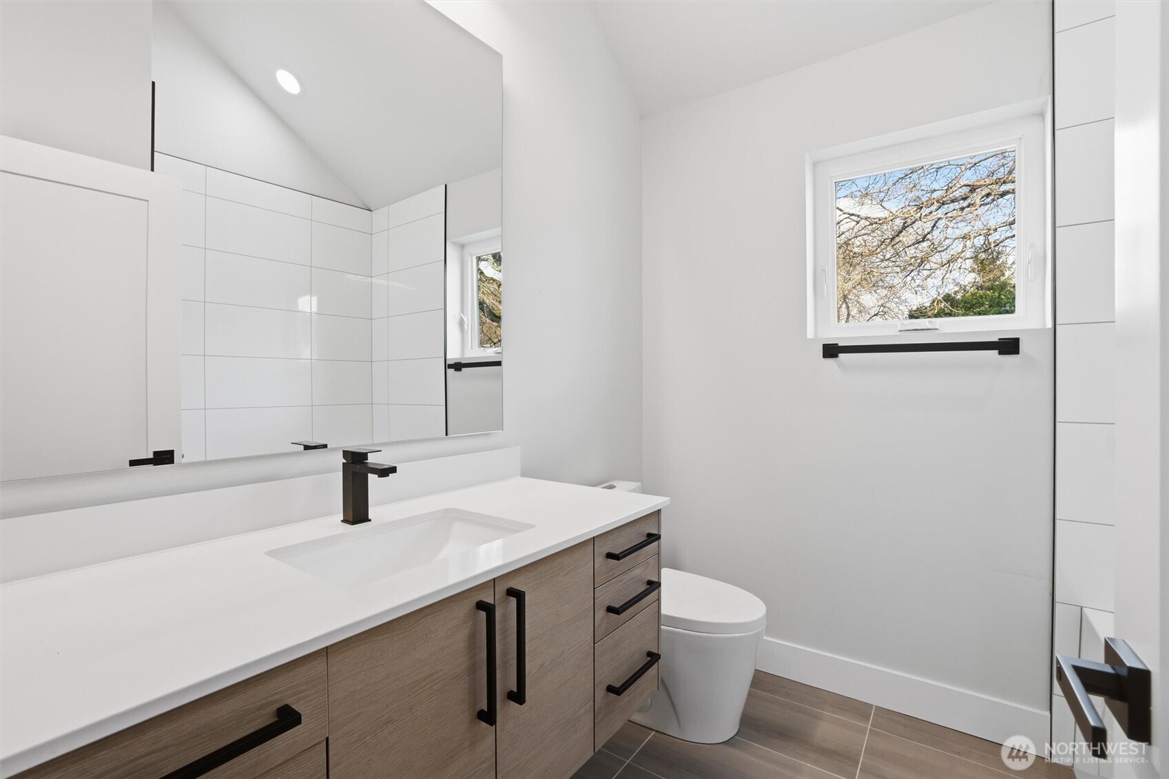 3324 35th Avenue South, Unit A Seattle, WA 98144 - Photo 14 of 20 a bathroom with a granite countertop sink toilet and a mirror