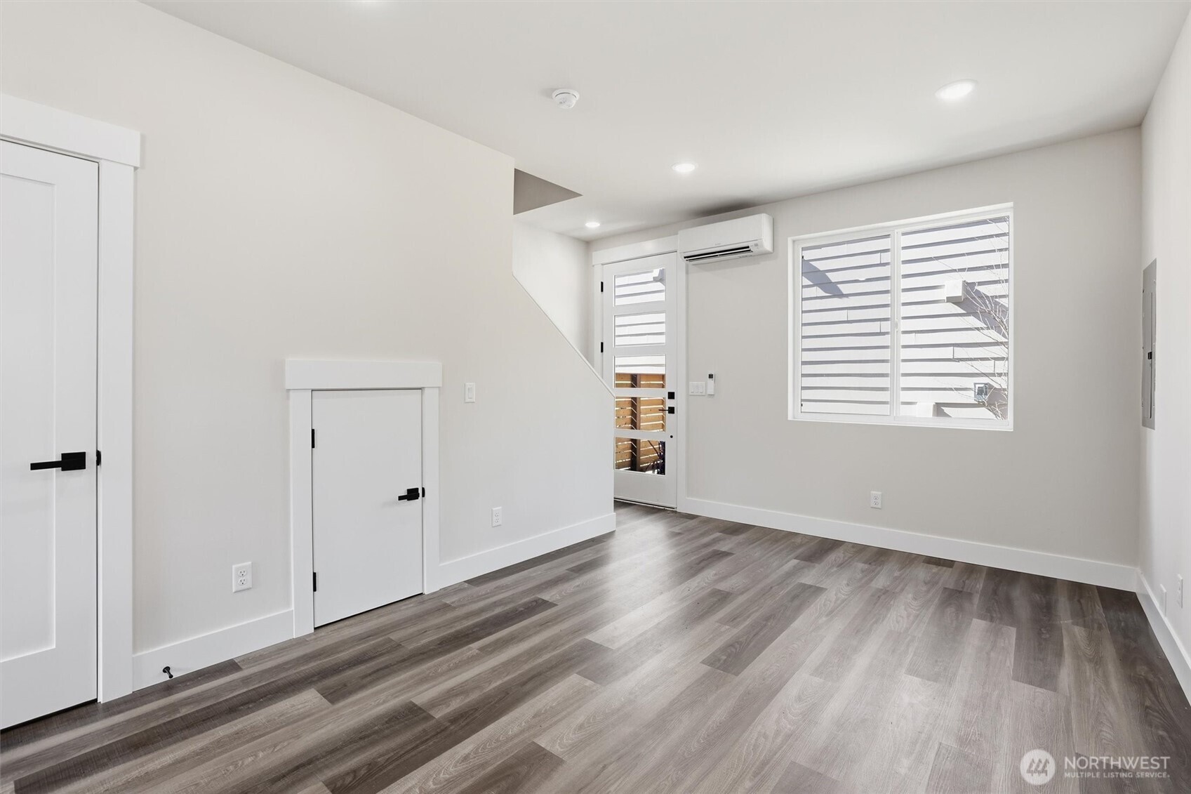 3324 35th Avenue South, Unit A Seattle, WA 98144 - Photo 6 of 20 a view of an empty room with wooden floor and a window