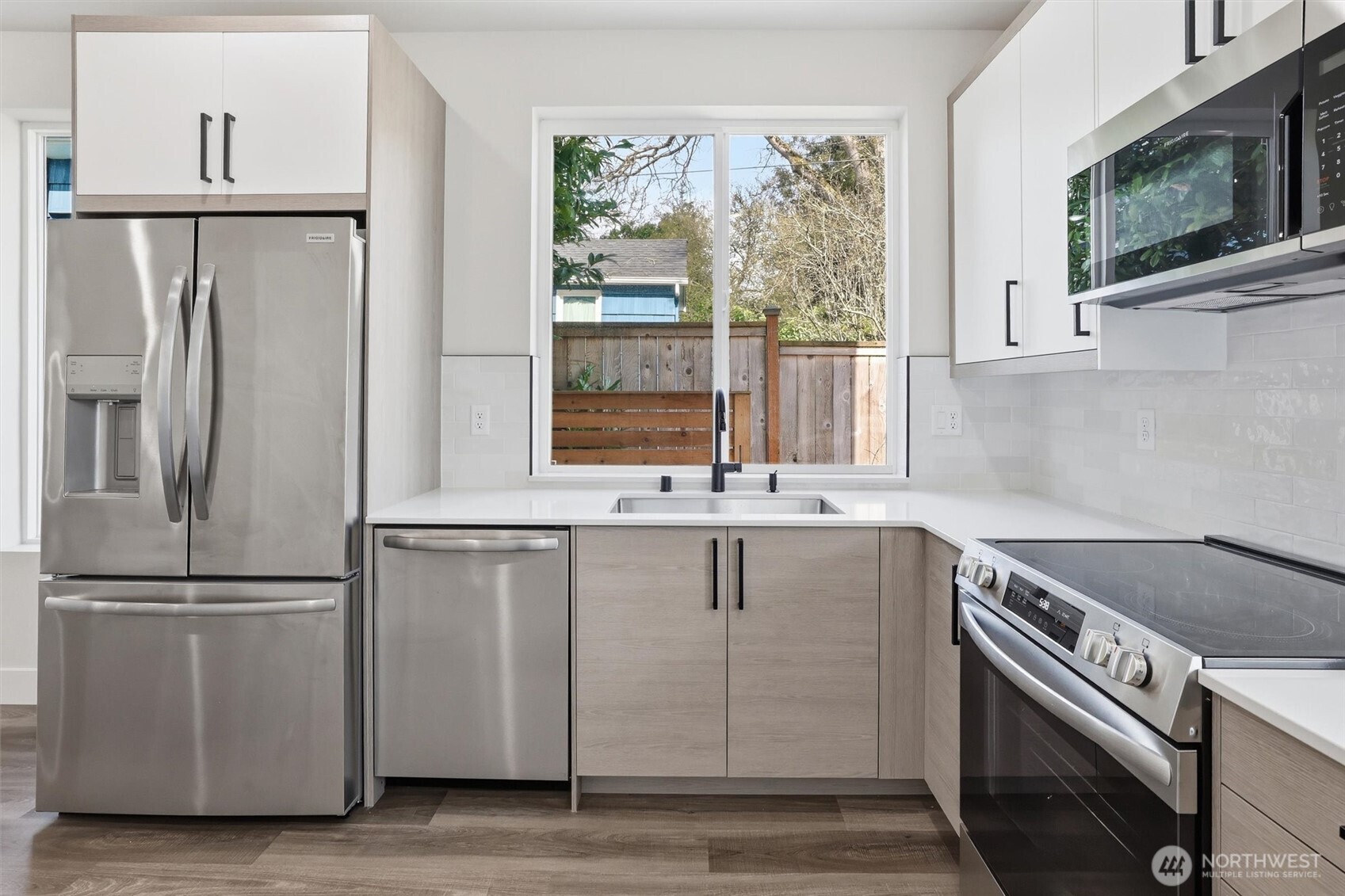 3324 35th Avenue South, Unit A Seattle, WA 98144 - Photo 9 of 20 a kitchen with white cabinets and a window