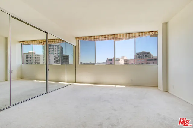 a bathroom with a granite countertop double vanity sink a mirror and a bathtub
