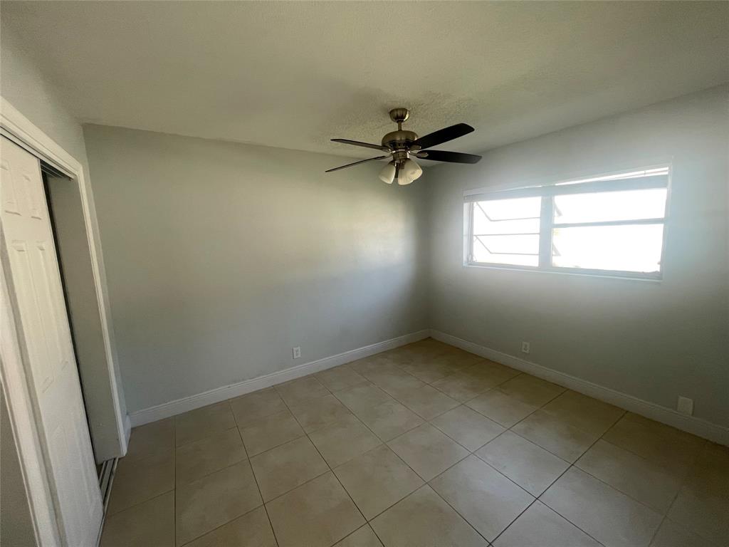 363 Southwest 15th Street, Unit 4 Pompano Beach, FL 33060 - Photo 13 of 16 an empty room with a window