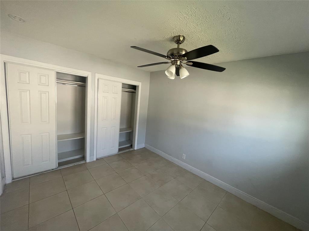 363 Southwest 15th Street, Unit 4 Pompano Beach, FL 33060 - Photo 15 of 16 an empty room with a fan & a window