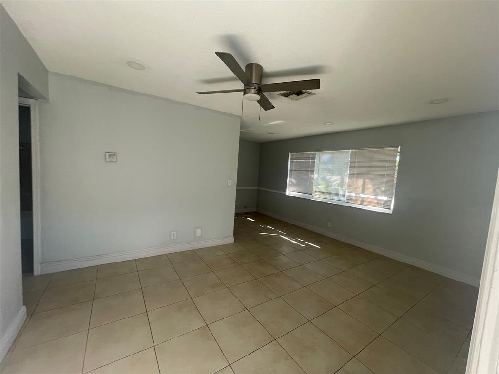 363 Southwest 15th Street, Unit 4 Pompano Beach, FL 33060 - Photo 8 of 16 a view of an empty room with a window