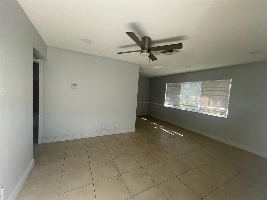 363 Southwest 15th Street, Unit 4 Pompano Beach, FL 33060 - Photo 9 of 16 a view of an empty room with a window