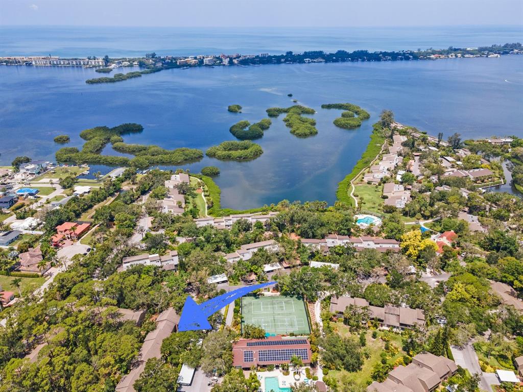 1701 Pelican Cove Road, Unit 359 Sarasota, FL 34231 - Photo 3 of 37 an aerial view of a house with a lake view