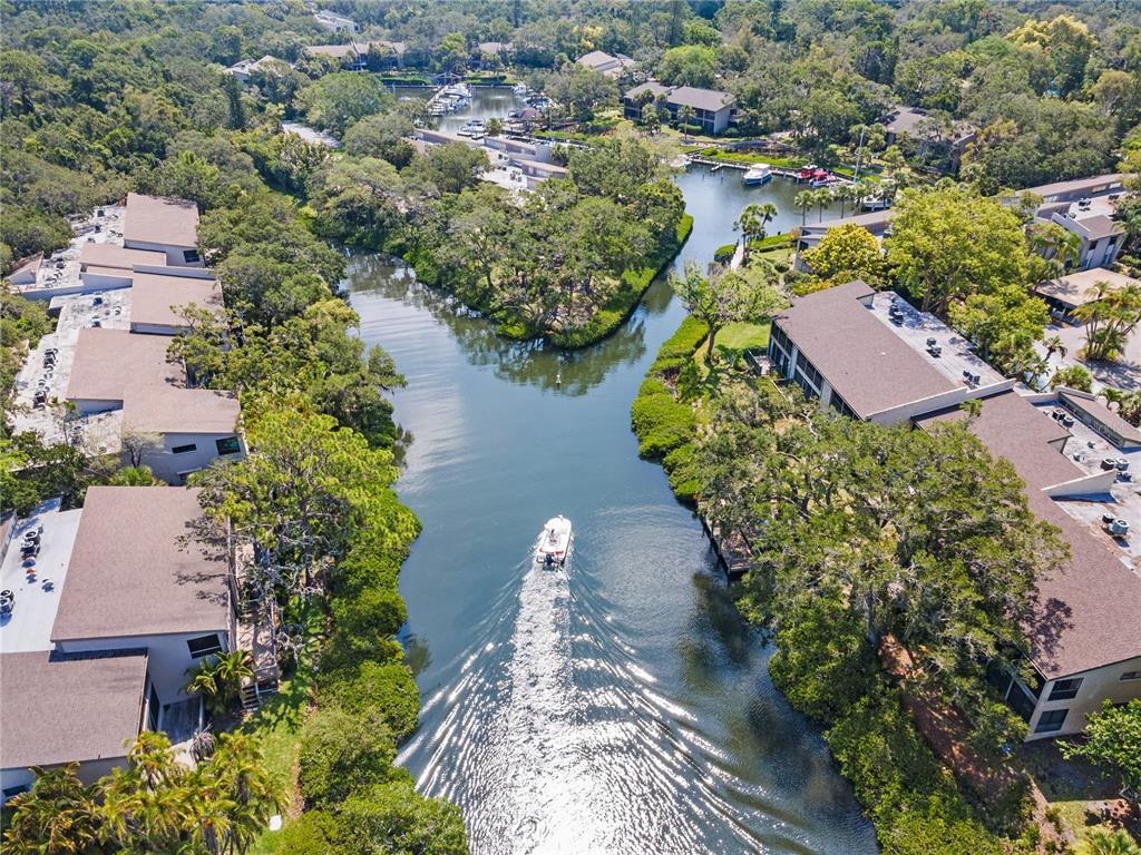 1701 Pelican Cove Road, Unit 359 Sarasota, FL 34231 - Photo 33 of 37 an aerial view of a house with a yard and lake view