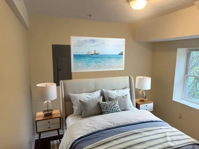 a bedroom with a bed and a window