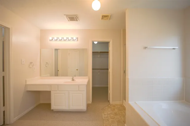 a bathroom with a sink a shower and a mirror