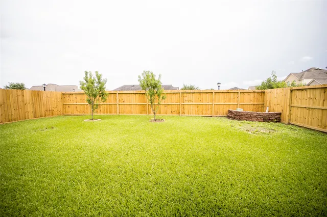 a large kitchen with stainless steel appliances granite countertop a sink stove and refrigerator