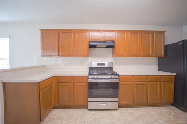 a kitchen with a stove and a cabinets