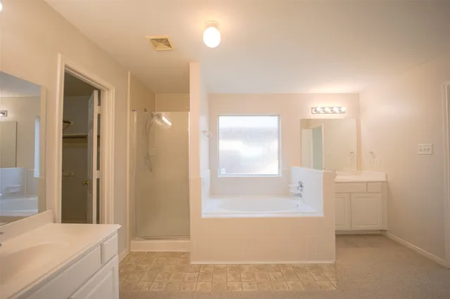 a bathroom with a bathtub and a sink
