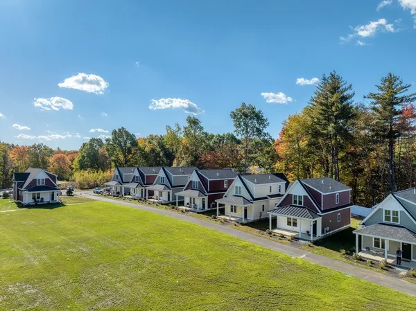a aerial view of a house with swimming pool and a yard