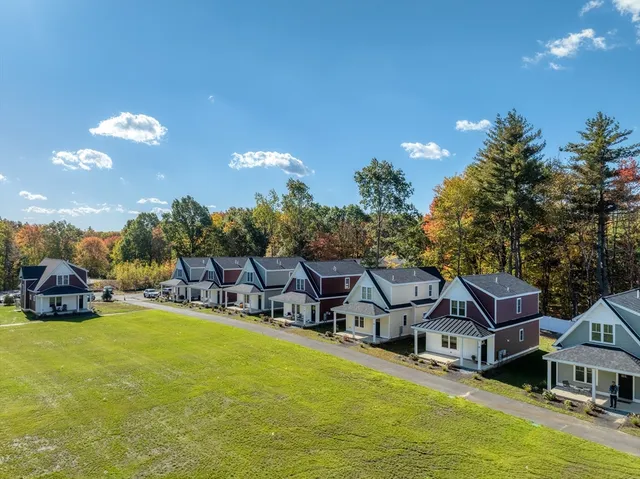 a aerial view of a house with swimming pool and a yard