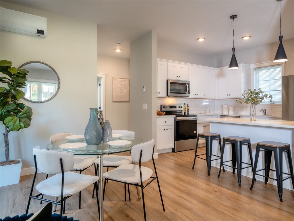 30 Cottage Lane Lancaster, MA 01523 - Photo 6 of 16 a kitchen with granite countertop a table chairs stove and cabinets