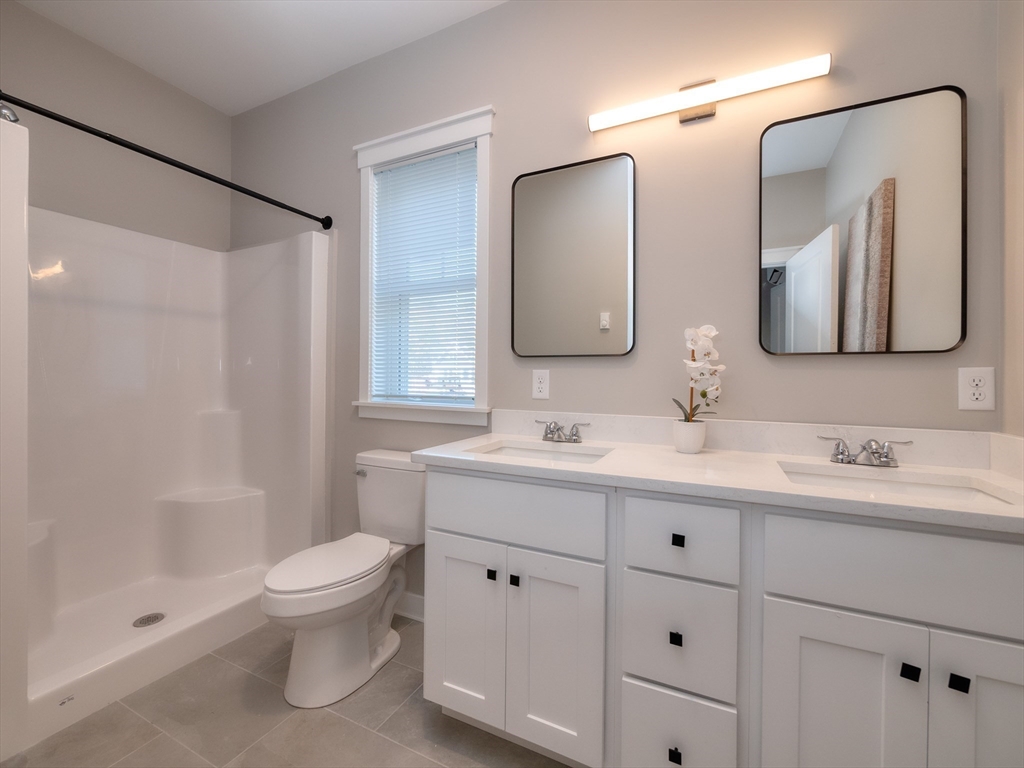 30 Cottage Lane Lancaster, MA 01523 - Photo 9 of 16 a bathroom with a double vanity sink toilet mirror and shower