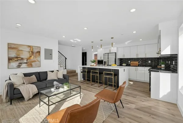 a living room with furniture and kitchen view