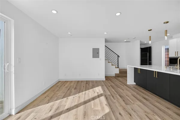 a view of kitchen with furniture and wooden floor