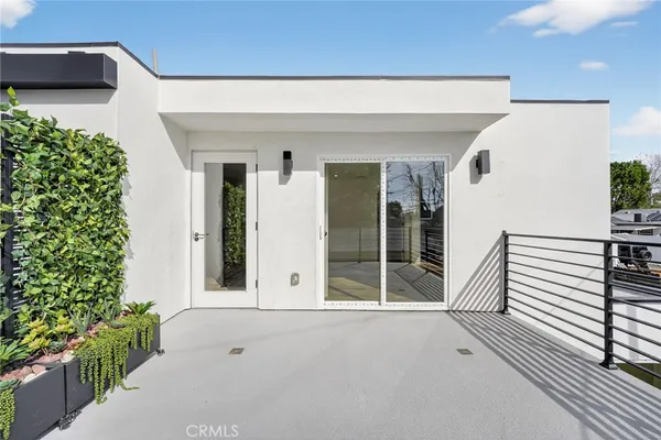 a very nice looking house with potted plants
