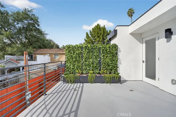 a view of a room with wooden floor and white walls