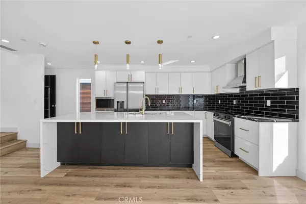 a kitchen with stainless steel appliances granite countertop a stove and a sink