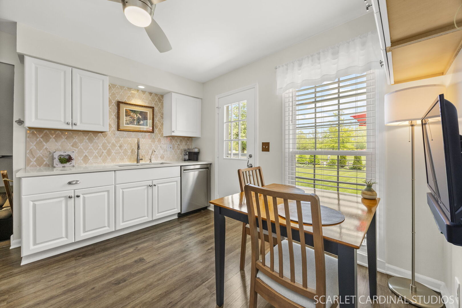1677 Casa Solana Drive Wheaton, IL 60189 - Photo 10 of 30 a kitchen with stainless steel appliances granite countertop a refrigerator a stove a sink and a dishwasher with wooden floor
