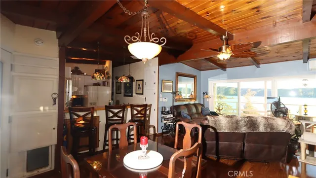 a living room with furniture a flat screen tv and a floor to ceiling window
