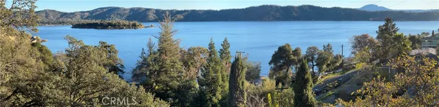 a living room with furniture floor to ceiling window and wooden floor