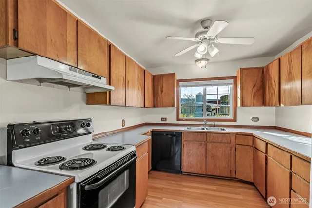a kitchen with a stove a sink and cabinets