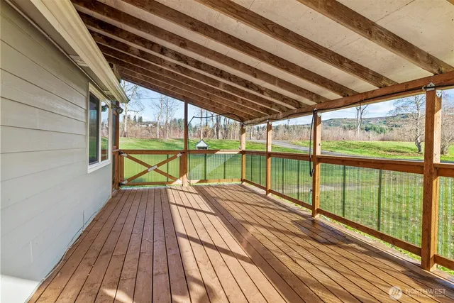 a view of balcony with wooden floor
