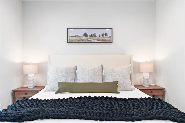 a view of a bedroom with bed and cabinet