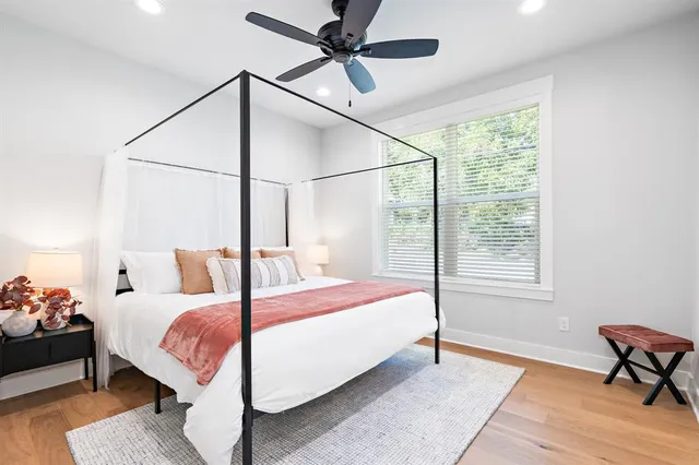 a bedroom with a bed a table and chair