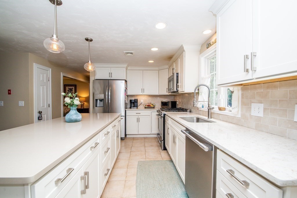 25 Squirrel Island Road Wareham, MA 02576 - Photo 17 of 39 a large kitchen with kitchen island a large counter space a sink appliances and cabinets