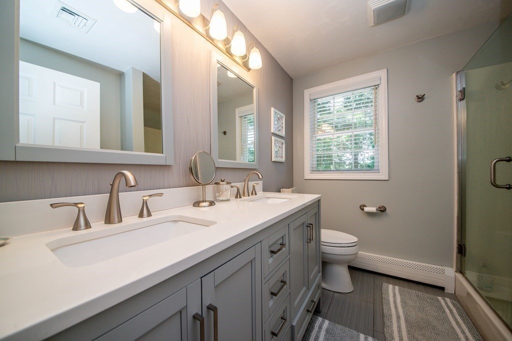 25 Squirrel Island Road Wareham, MA 02576 - Photo 25 of 39 a bathroom with a double vanity sink toilet and a mirror