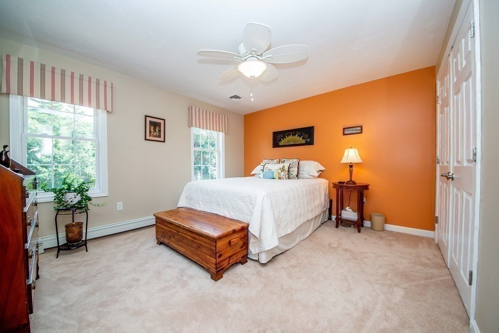 25 Squirrel Island Road Wareham, MA 02576 - Photo 27 of 39 a spacious bedroom with a bed and a chandelier