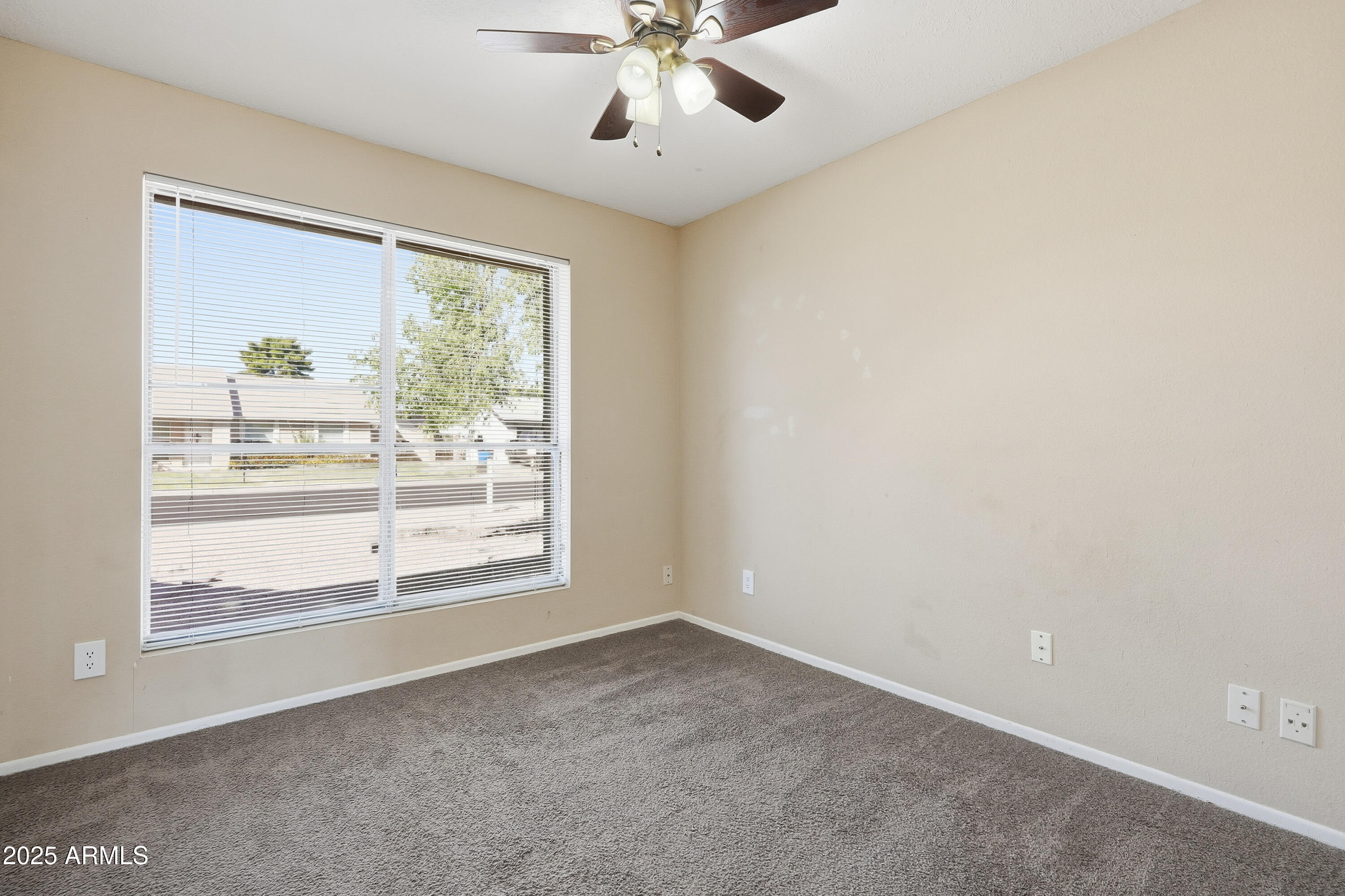 953 East Hackamore Street Mesa, AZ 85203 - Photo 26 of 44 an empty room with a window and a ceiling fan