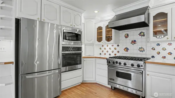 a kitchen with stainless steel appliances a stove a microwave and a refrigerator