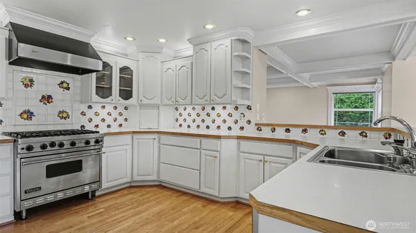 a kitchen with stainless steel appliances a stove a sink and a refrigerator