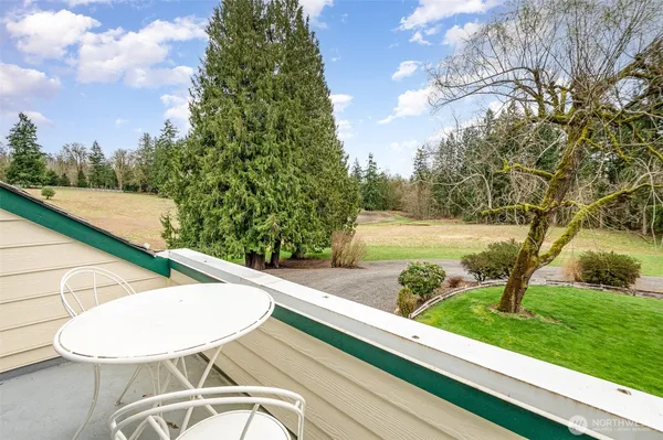 a view of a swimming pool with a patio and a yard