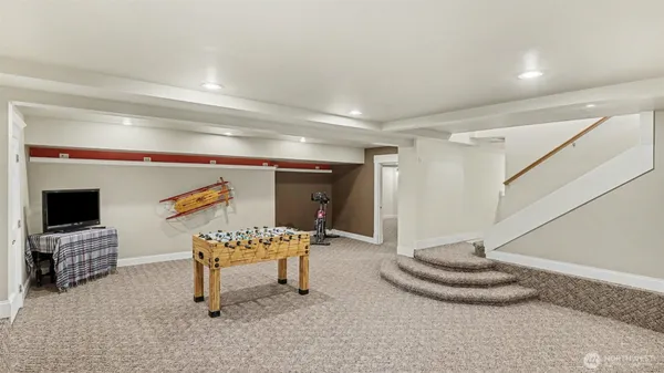 a bedroom with furniture and a flat screen tv