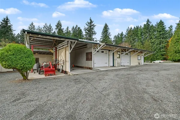 a view of a house with a patio and a yard